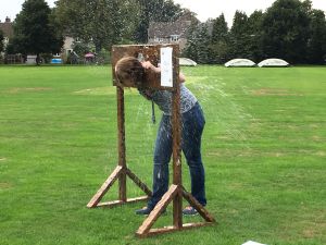 Lady playing medieval stocks