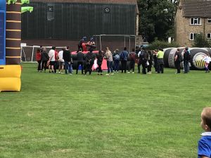 Crowd of People watching the Contestants Playing the inflatable Gladiator