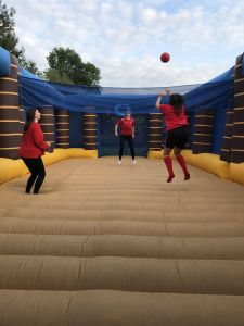 Ladies playing inflatable volleyball