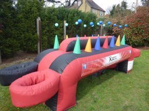 Inflatable air racer game set up with floating balls on a red and black game.