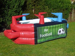 Air football game set up on a field at an event.