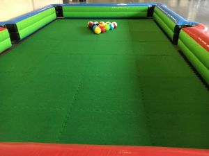 Football Pool game set up for an indoor event with an inflatable surround and astroturf pitch.