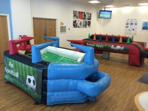 Inflatable air football and keep uppy game at an indoor football themed event.