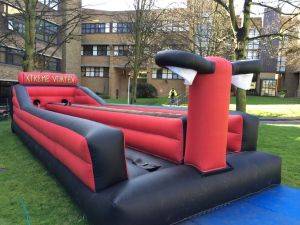 Inflatable bungee run game set up at a college for a freshers event.