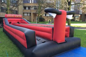 Thumbnail of an inflatable bungee run game set up for a college freshers event.