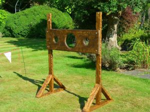 Junior Medieval stocks game set up in a garden for a side stall event.