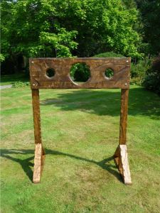 Medieval stocks game ready for players to throw wet spongers at people as they put their head through the game.