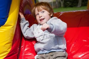 Closeup of Toddler on an inflatable slide on the Childrens Playzone