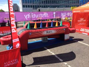 Inflatable under pressure game set up at a touch rugby event complete with branding around the game.