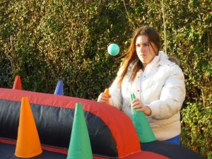 Female playing on an inflatable under pressure game at a team building event.